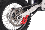 Close-up of a motorcycle's rear wheel and chain, showcasing high-performance racing components from Grand Prix Racewear.