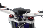 Close-up of a motorcycle handlebar with suspension components and control grips, highlighting high-performance racing equipment.