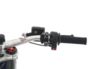 Close-up of a motorcycle handlebar with control switches and throttle grip, used in racing or off-road riding.