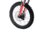 Close-up of a mountain bike front wheel with disc brake and knobby tyre, suitable for off-road cycling.