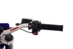 Close-up of a motorcycle handlebar with a black grip, throttle, and warning label, suitable for racing or off-road riding.