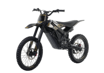 Electric dirt bike with black and gold design, suitable for motocross and off-road racing, featuring rugged tires and advanced suspension.