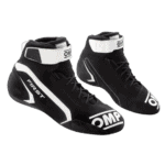 Black and white OMP racing shoes with ankle support and laces, designed for motorsport drivers, featuring branding and lightweight construction.