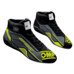High-performance OMP Grand Prix racing shoes in black and yellow with racing branding, designed for motorsport enthusiasts and professional drivers.