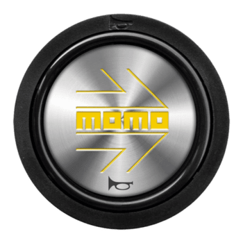 Grand Prix Racewear logo on a circular metallic badge with black border, featuring yellow and grey design elements.