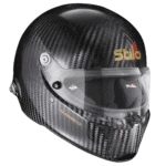 Stilo racing helmet with carbon fibre finish, designed for motorsport safety and performance, featuring a clear visor and aerodynamic shape.