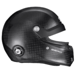 Carbon fibre racing helmet with clear visor, designed for motorsport safety and performance.