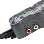 Close-up of a racing helmet communication system with Out and In audio jacks, used in motorsport racing for driver communication.
