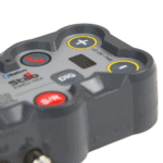 Close-up of a racing intercom device with buttons for communication and control, used in motorsport events.