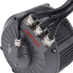 Close-up of a Votion electric motor with multiple black cables connected, showcasing its industrial design and cooling fins.