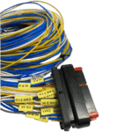 Close-up of a bundle of multicoloured wires with a black connector, used in racing car electronics and telemetry systems.