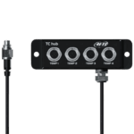 A TC hub device with four temperature sensor ports, used in motorsport for monitoring engine temperatures, featuring a black metal casing and connected cables.