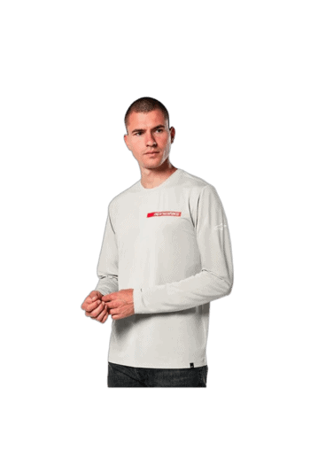 Male model wearing Grand Prix Racewear long-sleeve racing top with logo, showcasing professional motorsport apparel.