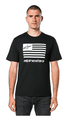 Man wearing Alpinestars racing T-shirt with logo and stripes, standing against a green background.