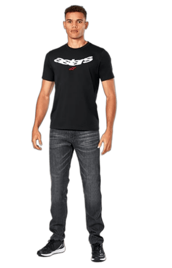 Young man wearing a black Astars T-shirt and jeans, standing confidently against a plain background.