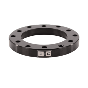 Black B-G Racing steering wheel spacer with multiple bolt holes for racing steering wheel installation.