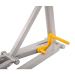 Close-up of a metal racing simulator pedal with a yellow brake pedal and grey frame, used for motorsport gaming and training.