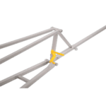 Close-up of a white racing car roll cage with a yellow safety latch against a black background.