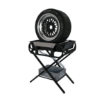 Race car tire mounted on a stand with a wheel gun and tools for racing events, showcasing high-performance racing equipment.