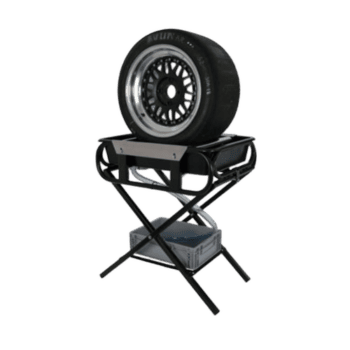 Race car tire mounted on a stand with a wheel gun and tools for racing events, showcasing high-performance racing equipment.
