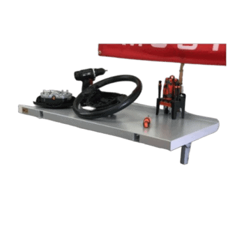 Race car steering wheel and racing simulator setup on a metal table with a red rear wing in the background.