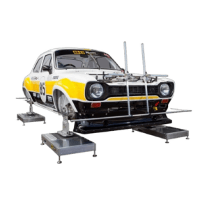 Classic racing car on a dynamometer for performance testing, featuring a white and yellow livery with racing number 85.