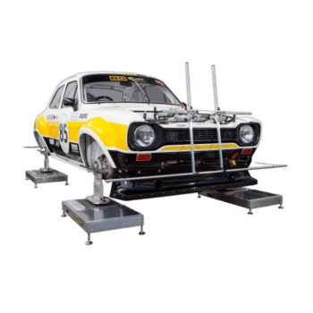 Classic racing car on a dynamometer for performance testing, featuring a white and yellow livery with racing number 85.
