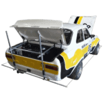 Classic race car with open rear trunk, featuring yellow and white livery, racing number 85, and rear wing, designed for motorsport events.