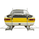 Classic racing car on a testing rig, showcasing Grand Prix Racewear's motorsport safety gear and equipment.