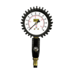Pressure gauge with black gear-like outer rim, measuring in bar and psi, used in racing or automotive applications.