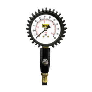Pressure gauge with black gear-like outer rim, measuring in bar and psi, used in racing or automotive applications.