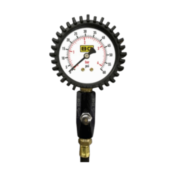Pressure gauge with black gear-like outer rim, measuring in bar and psi, used in racing or automotive applications.