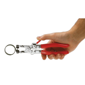 Grand Prix Racewear self-tightening clamp pliers DM.29 held in a person's hand, showcasing their ergonomic design and compact size.