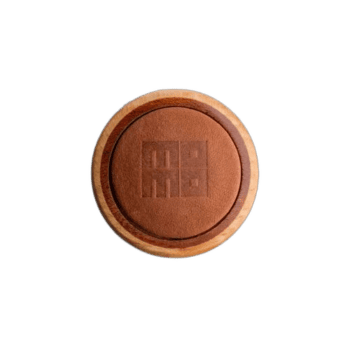 Close-up of a round wooden token with the number 88 engraved on it, used in motorsport events.