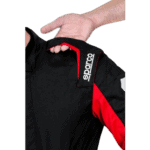 Close-up of a racing suit with Sparco branding, showing black and red fabric details.