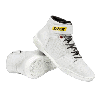 White Sabelt racing shoes with black laces and yellow Sabelt logo, designed for motorsport safety and performance.