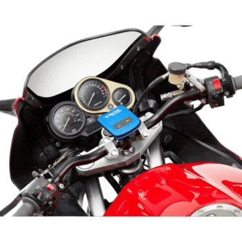 Close-up of a motorcycle dashboard with speedometer, tachometer, and GPS device mounted on the handlebar.