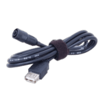 Close-up of a black power cable with a USB connector and a 3.5mm audio jack, secured with a black velcro strap, on a black background.