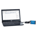 Dell laptop connected to Racelogic CAN Gateway device used for data analysis in motorsport applications.