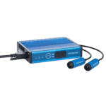 Racelogic racing data logger with blue casing and connected sensors for motorsport analysis.