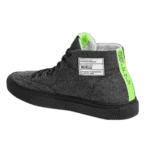 Black Grand Prix Racewear sneaker with neon green accents and label, designed for motorsport enthusiasts and racers.