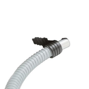 Close-up of a high-performance racing spark plug with a white cable, used in motorsport vehicles for optimal ignition.