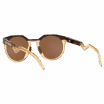 Oakley HSTN Kylian Mbappé sunglasses with round brown lenses and gold frame, stylish and sporty eyewear for active lifestyles.