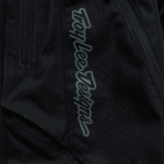 Close-up of Troy Lee Designs SCOUT GP PRO Mono Bottoms showing logo and fabric details for motocross gear.