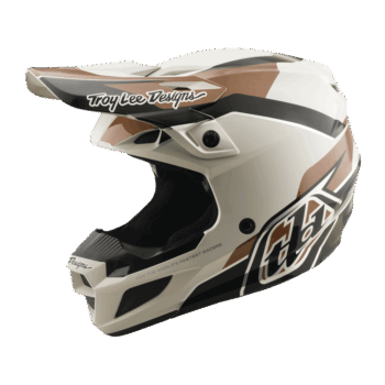 Troy Lee Designs SE5 Polycarbonate Stand Helmet in white with black and brown accents, featuring aerodynamic design and branding for motocross safety.